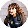 photo of a woman with brown hair wearing a police vest